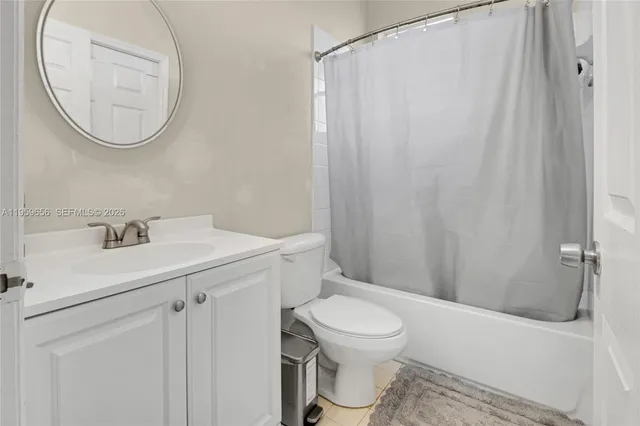 a bathroom with a toilet a sink and a mirror