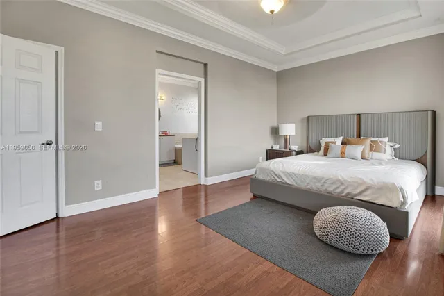 a bedroom with bed and wooden floor