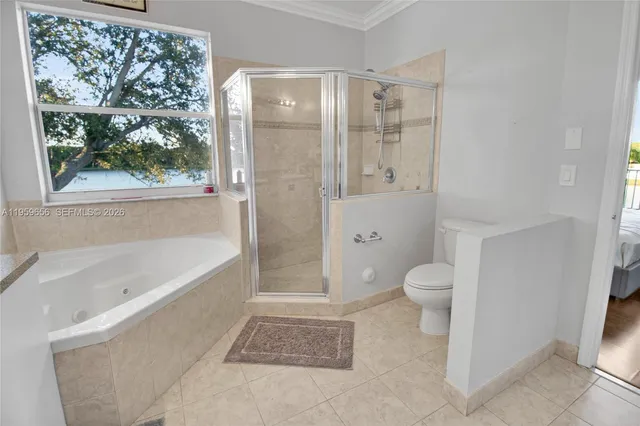 a bathroom with a granite countertop bathtub shower and toilet