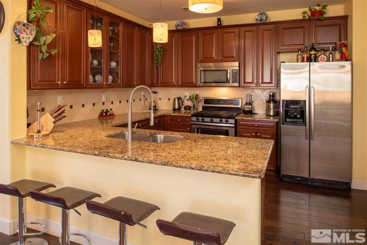 301 Manciano Way Reno, NV 89521 - Photo 1 of 20 a kitchen with stainless steel appliances granite countertop a sink refrigerator and microwave