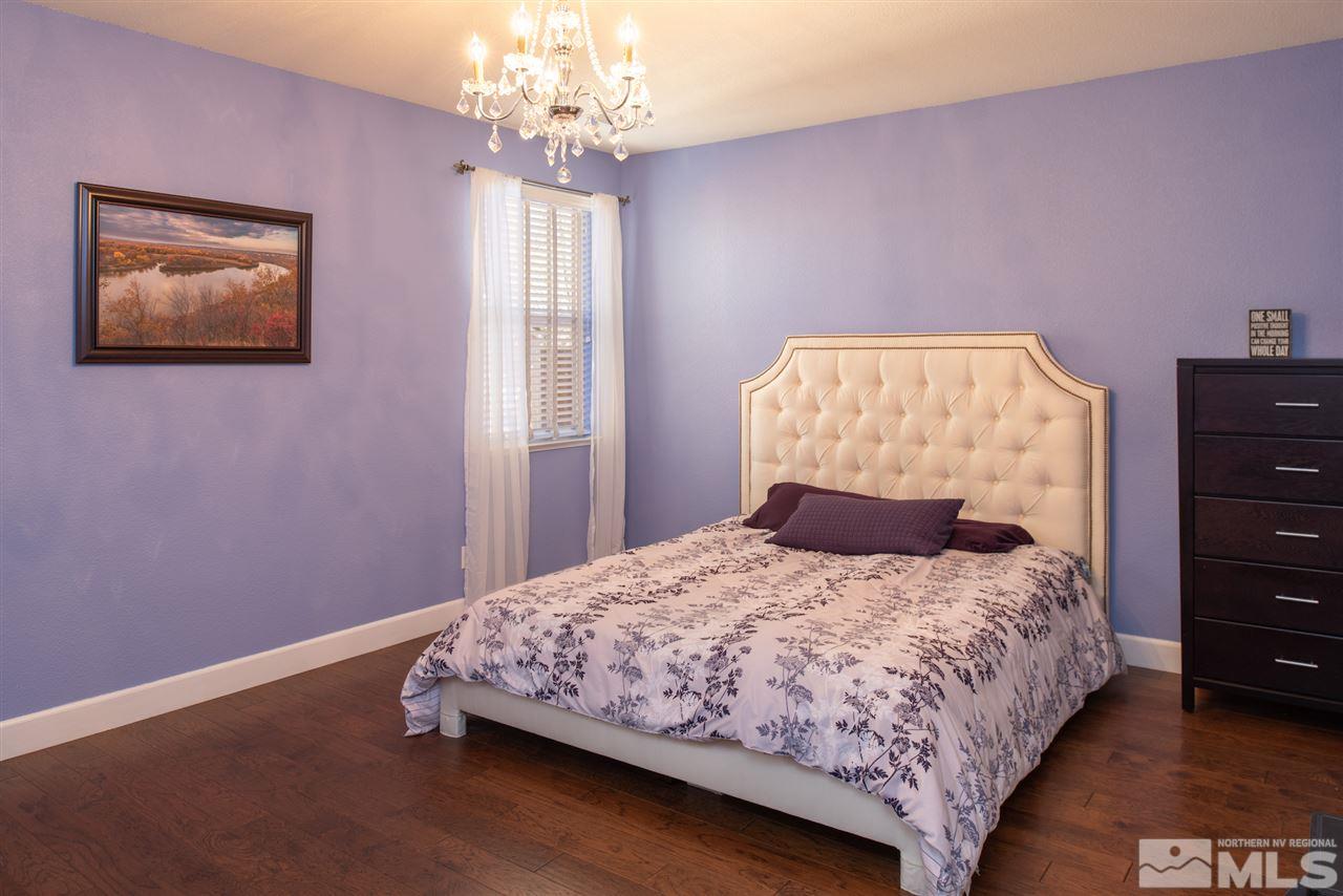 301 Manciano Way Reno, NV 89521 - Photo 8 of 20 a bedroom with a bed and a chandelier
