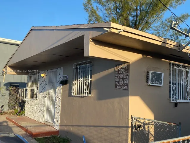 a roof deck with table and chairs