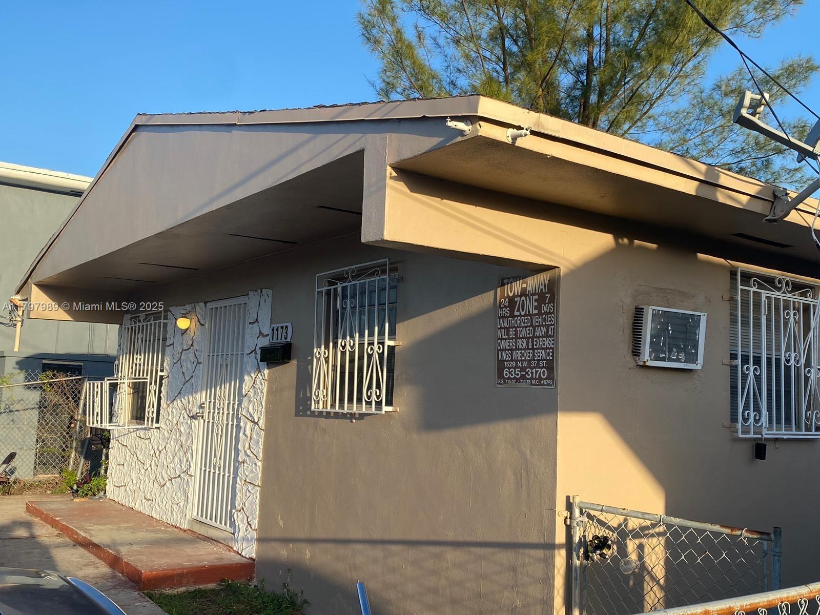 a roof deck with table and chairs