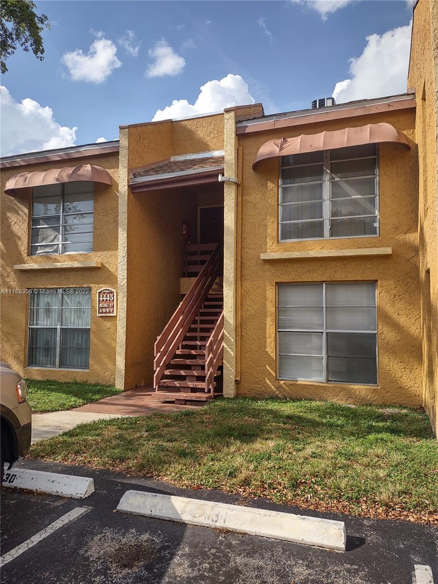 4445 Treehouse Lane, Unit A Tamarac, FL 33319 - Photo 1 of 16 a front view of a house