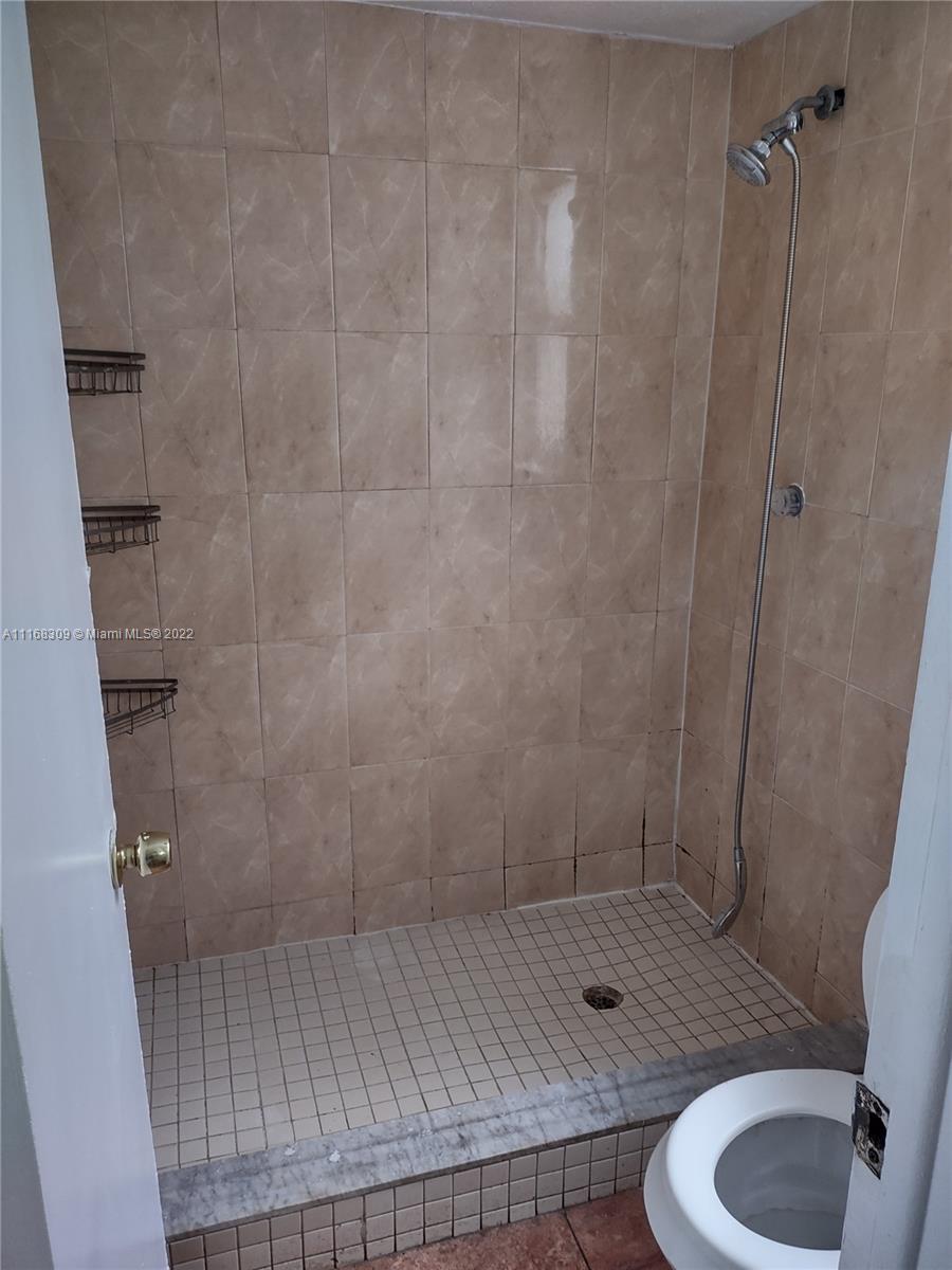 4445 Treehouse Lane, Unit A Tamarac, FL 33319 - Photo 12 of 16 a bathroom with a shower