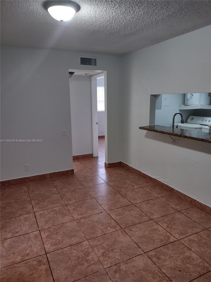 4445 Treehouse Lane, Unit A Tamarac, FL 33319 - Photo 5 of 16 a view of a kitchen with a sink and a dishwasher