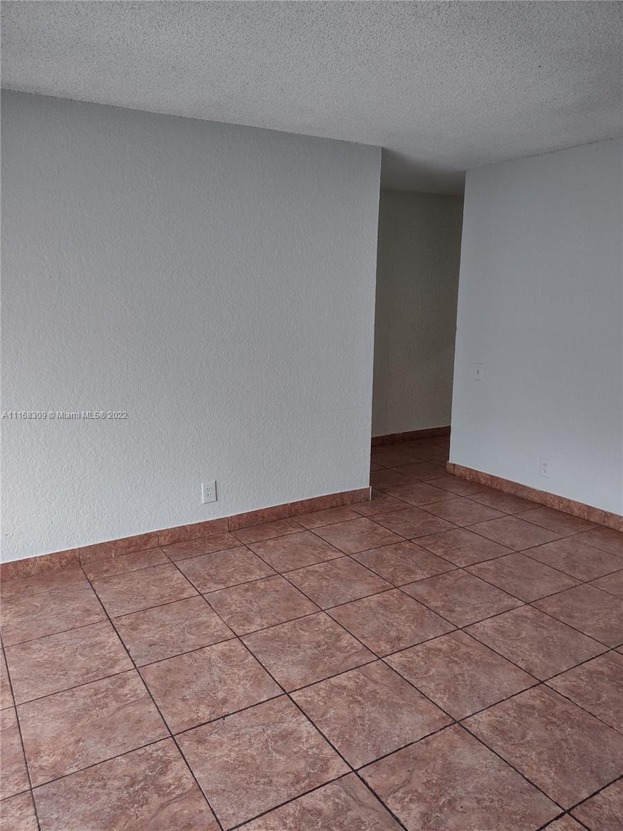 4445 Treehouse Lane, Unit A Tamarac, FL 33319 - Photo 10 of 16 a view of an empty room and street