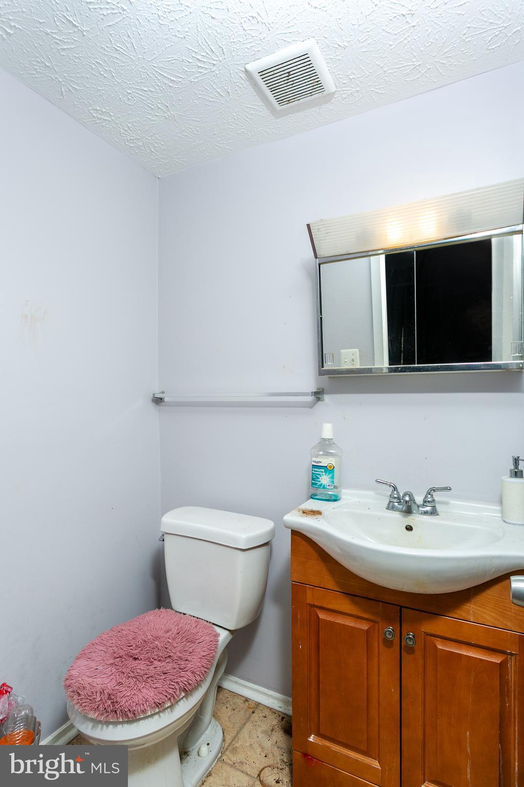 1217 Division Street Baltimore, MD 21217 - Photo 12 of 14 a bathroom with a sink a mirror and toilet