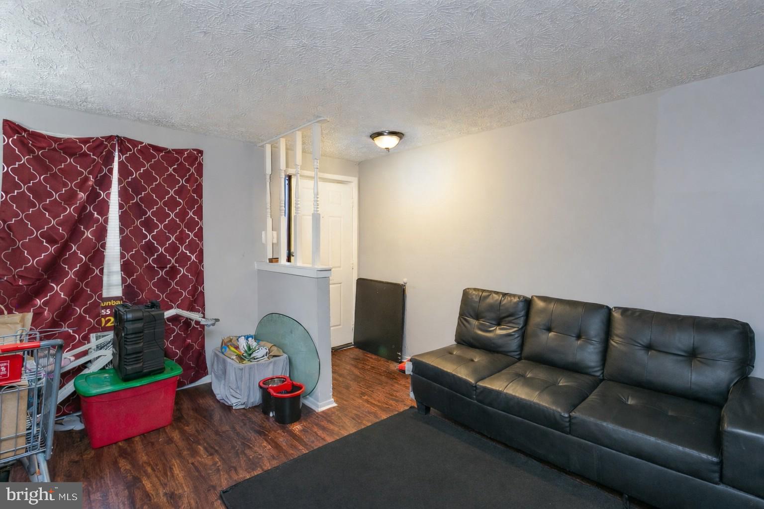 1217 Division Street Baltimore, MD 21217 - Photo 5 of 14 a living room with furniture stairs and a potted plant