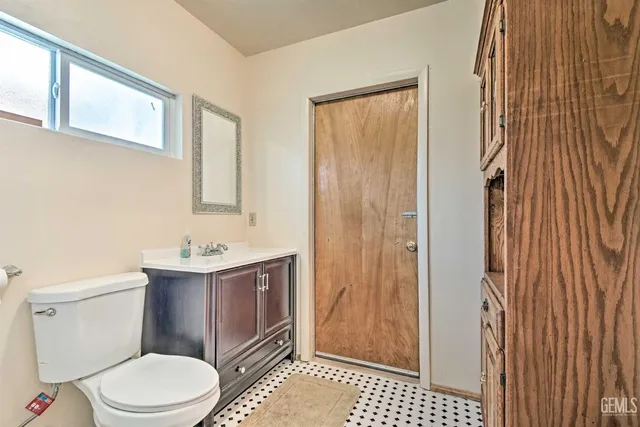 a bathroom with a toilet a sink and shower