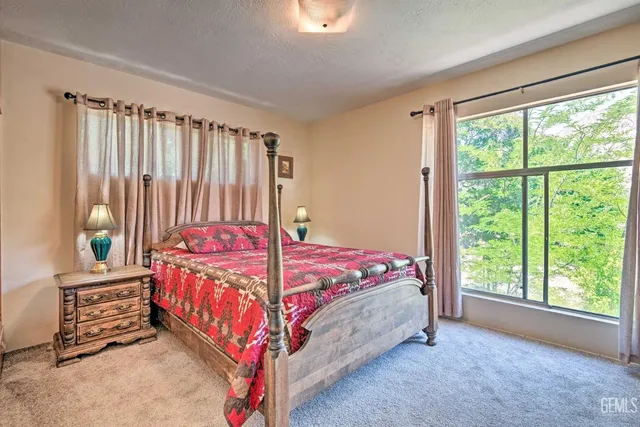 a bed sitting in a bedroom next to a window