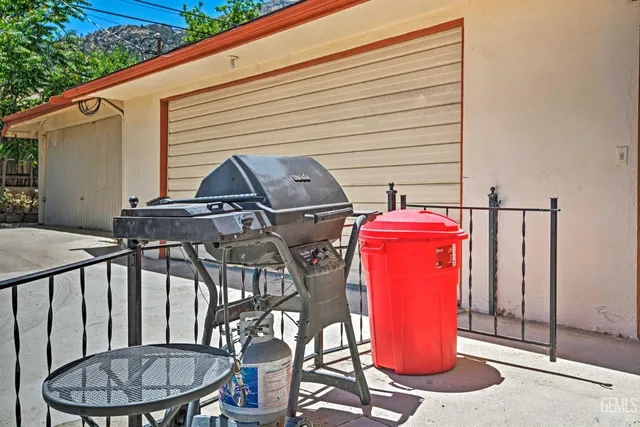 a view of a balcony with chairs and wooden floor