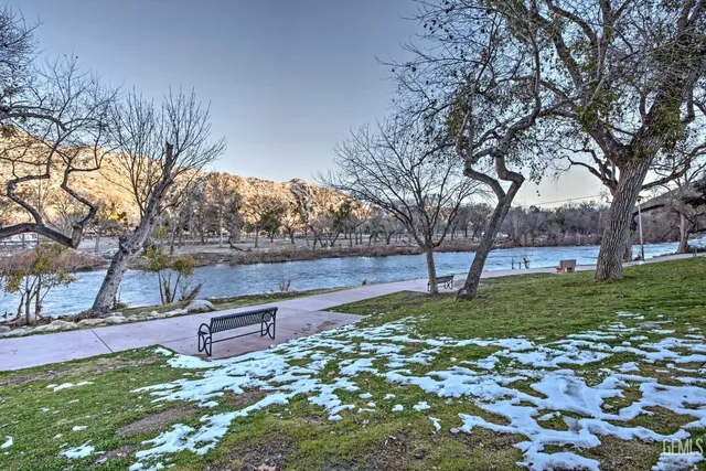 a park view with wooden fence and trees