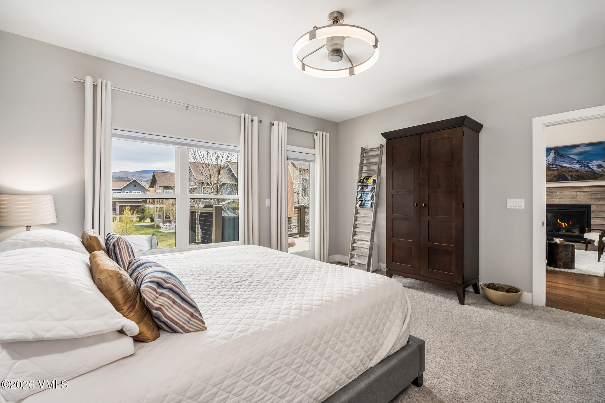 54 Field Street Eagle, CO 81631 - Photo 14 of 36 a bedroom with a large bed and a chandelier