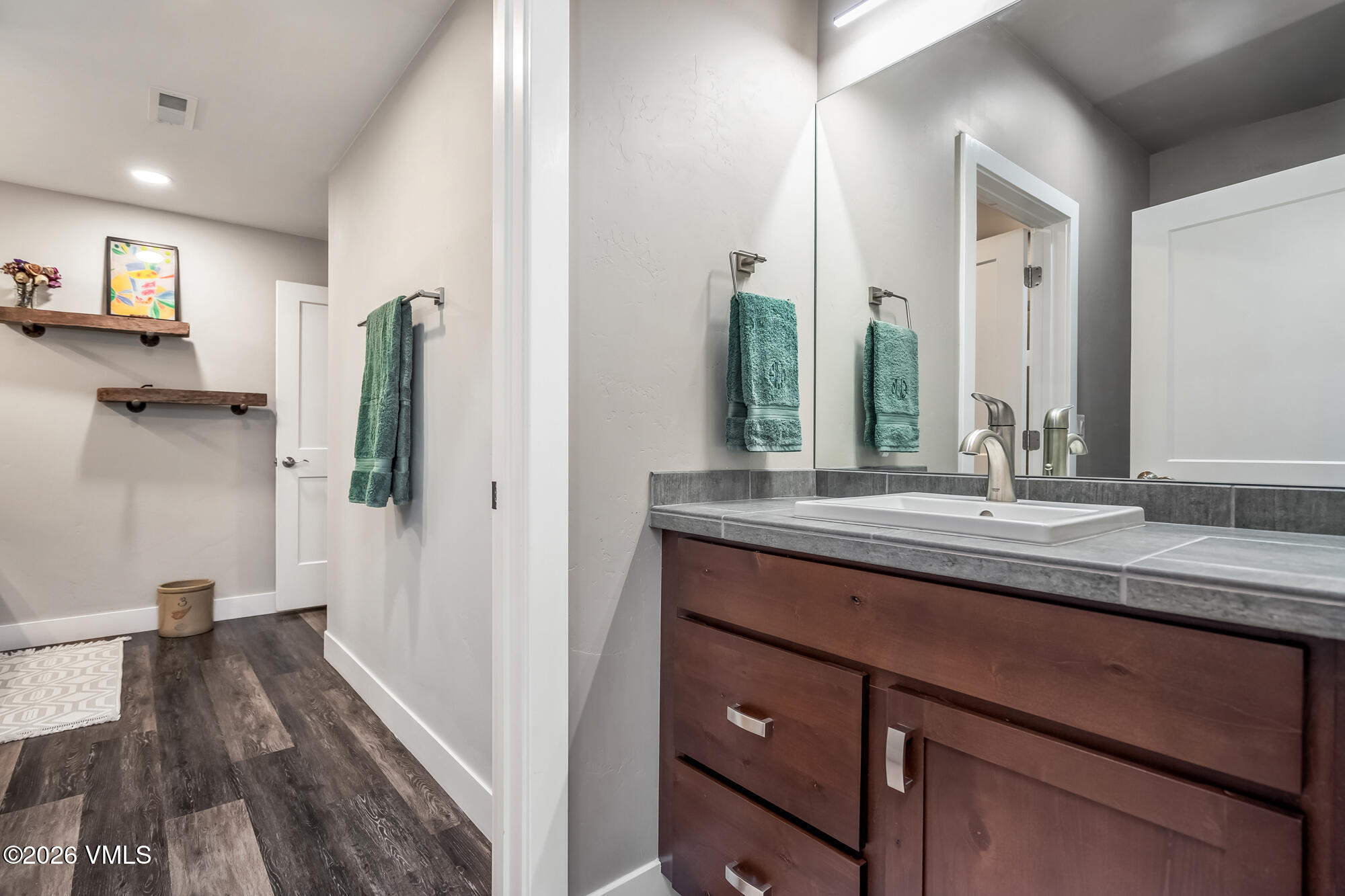 54 Field Street Eagle, CO 81631 - Photo 29 of 36 a bathroom with a granite countertop sink and a mirror