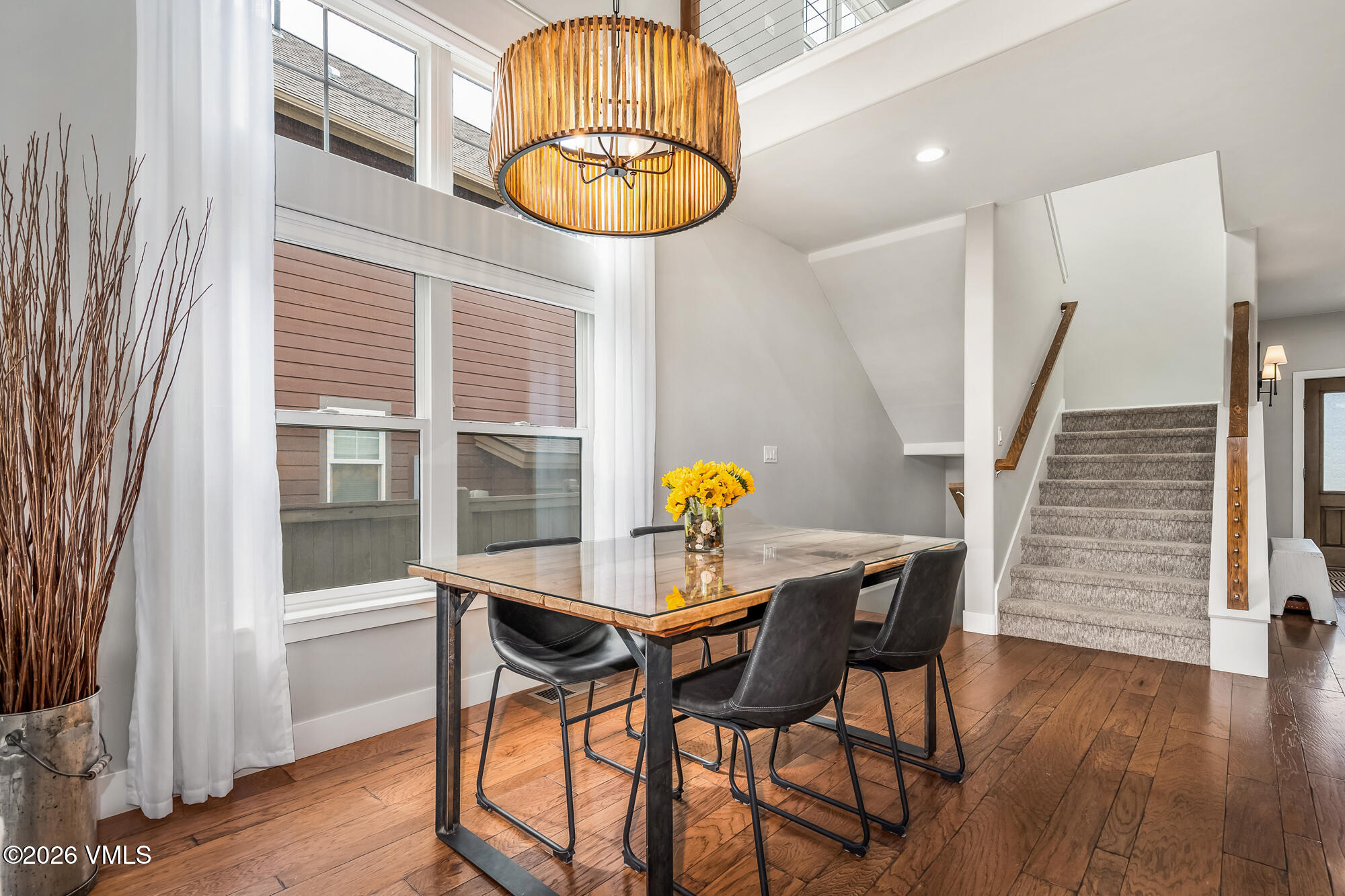 54 Field Street Eagle, CO 81631 - Photo 6 of 36 a view of a dining room with furniture a chandelier and wooden floor