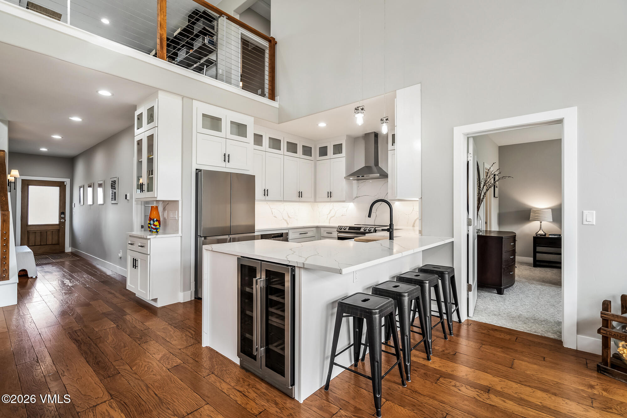 54 Field Street Eagle, CO 81631 - Photo 8 of 36 a kitchen with stainless steel appliances a stove top oven a sink dishwasher and a refrigerator with wooden floor