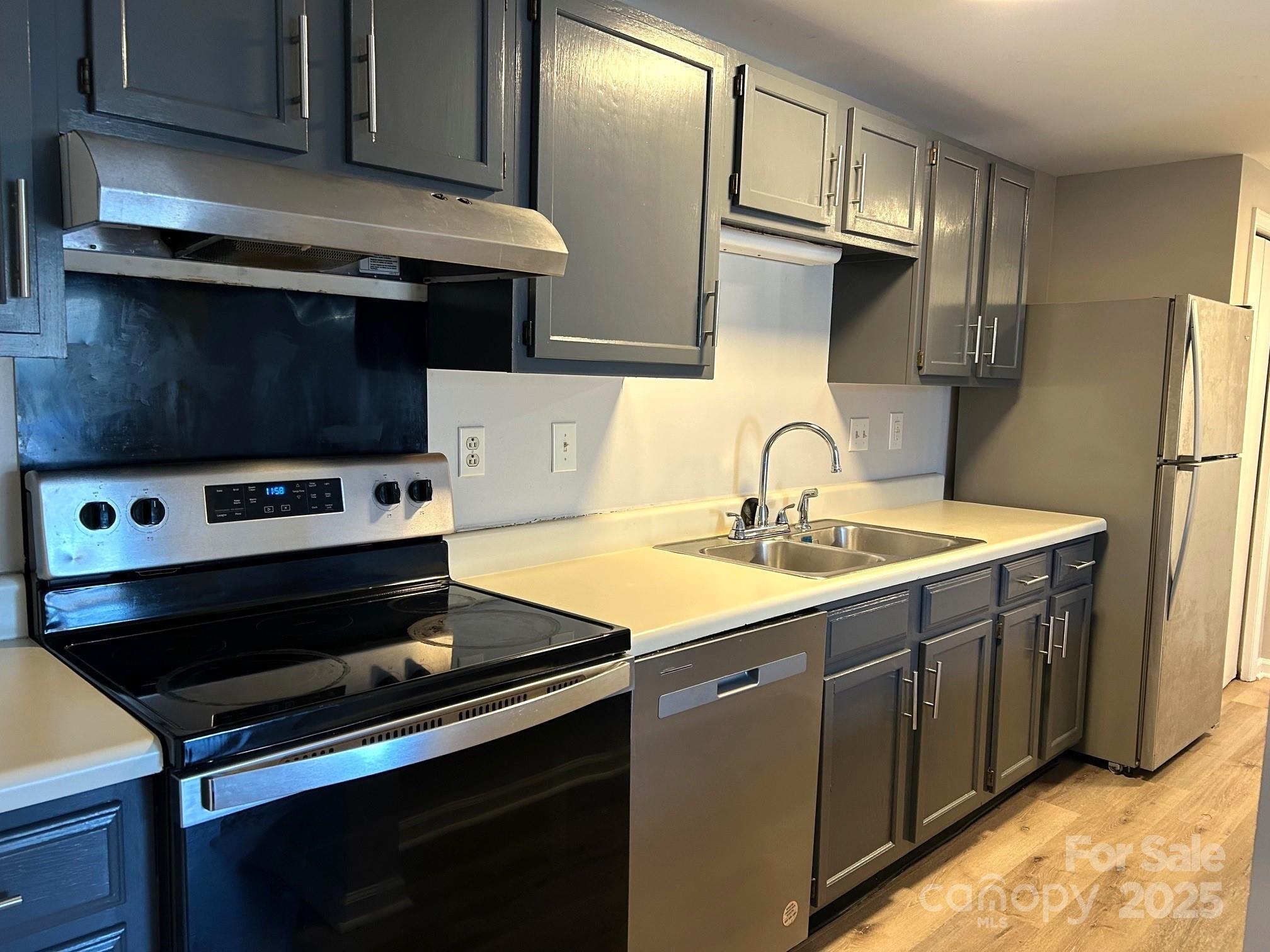 9401 Old Concord Road, Unit A Charlotte, NC 28213 - Photo 5 of 12 a kitchen with stainless steel appliances a sink stove and refrigerator