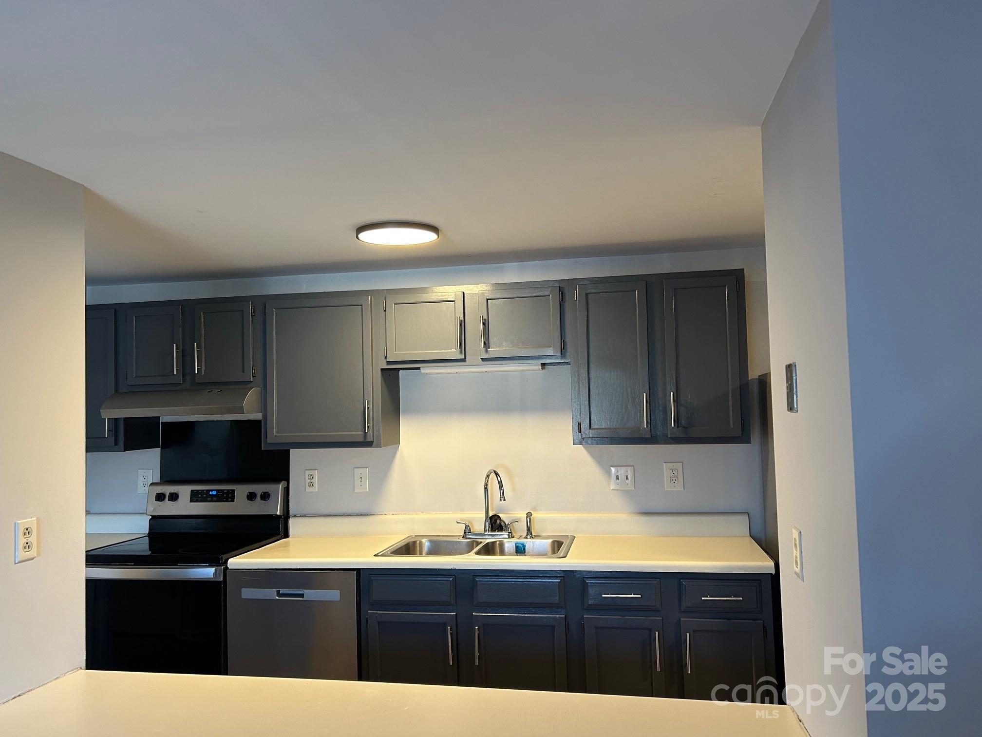 9401 Old Concord Road, Unit A Charlotte, NC 28213 - Photo 6 of 12 a kitchen with granite countertop a sink and cabinets