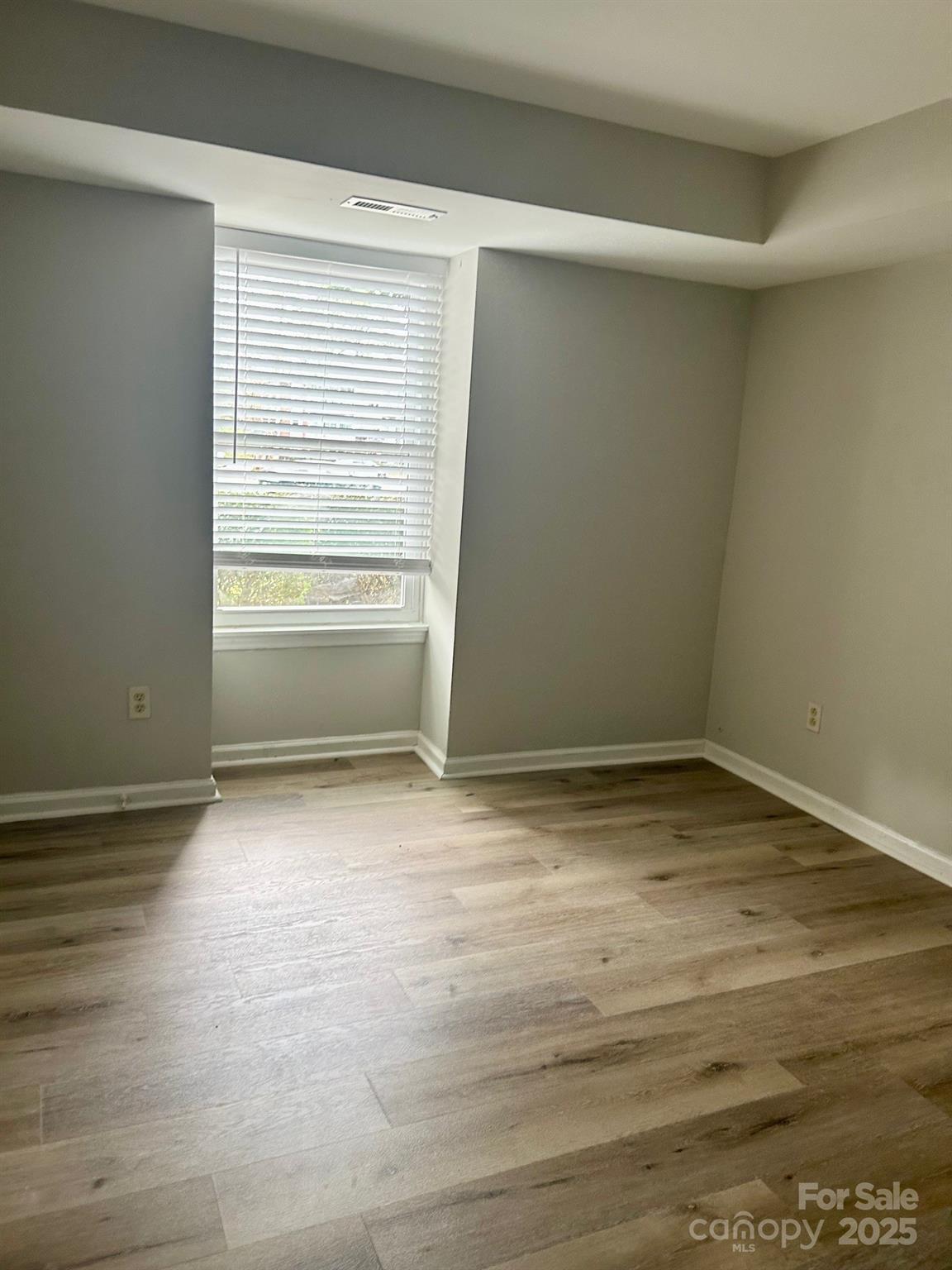 9401 Old Concord Road, Unit A Charlotte, NC 28213 - Photo 7 of 12 a view of empty room with wooden floor and fan