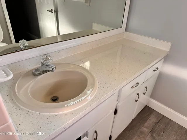 a bathroom with a sink and mirror