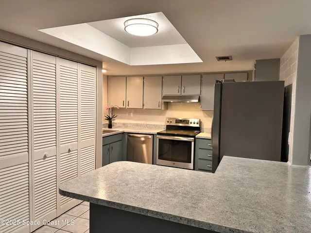 a kitchen with a refrigerator stove and sink