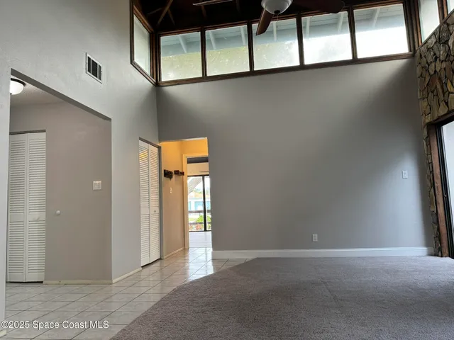 an empty room with windows and closet