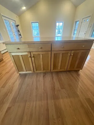 a kitchen with granite countertop wooden cabinets and a stove top oven