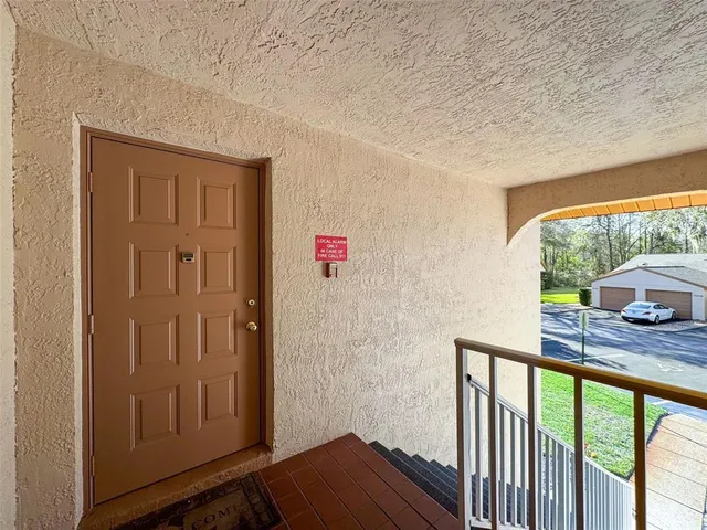 a view of a hallway with wooden floor and fence