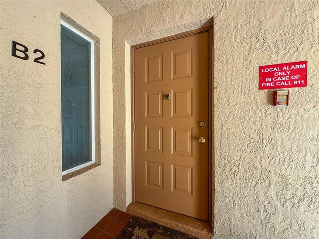 a living room with furniture a flat screen tv and a large window
