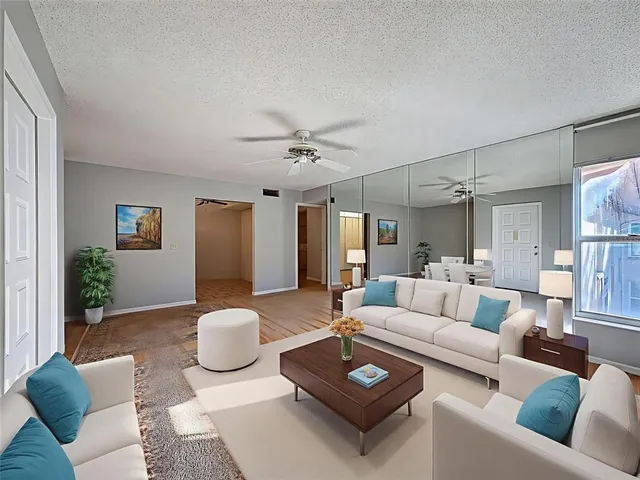 a view of a dining room with furniture and a chandelier