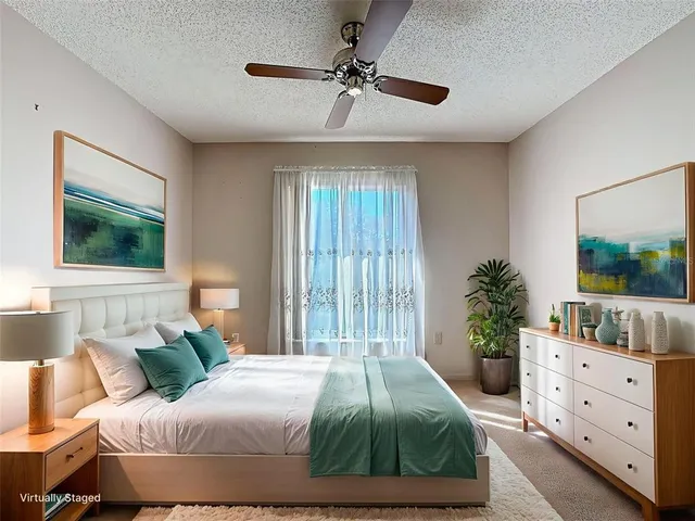 a bedroom with a large bed and a potted plant