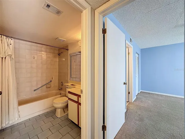 a bathroom with a sink mirror toilet and bathtub