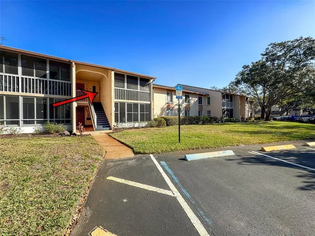 a view of a house with a patio and a yard