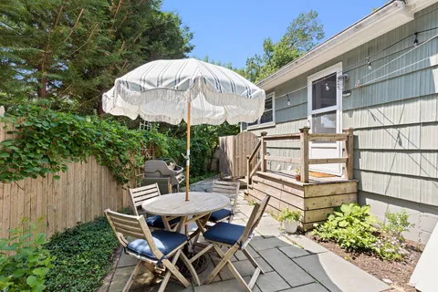 a view of a table and chairs under an umbrella