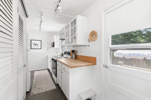 a kitchen with stainless steel appliances granite countertop a stove and a sink