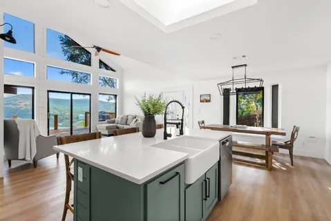 a view of living room kitchen with a table and chairs