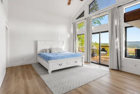 a room with a bed and large window