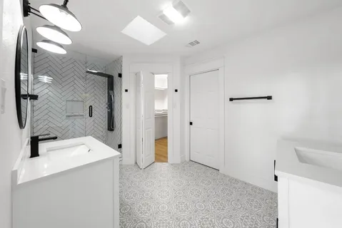a view of a bathroom with a sink mirror and shower
