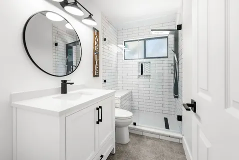 a bathroom with a sink a toilet and a mirror