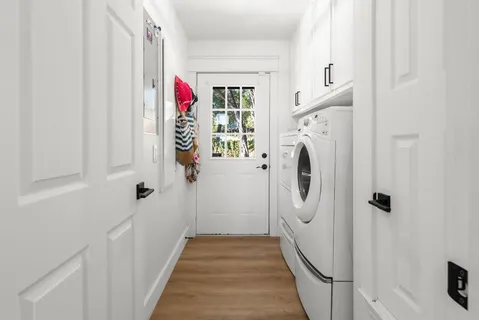 a view of a hallway with washer and dryer