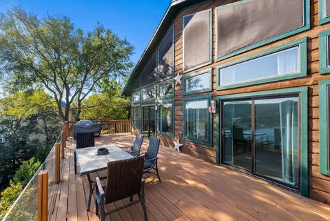 a view of a patio with table and chairs and potted plants