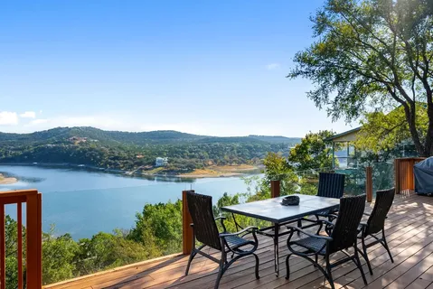a view of lake from balcony with furniture