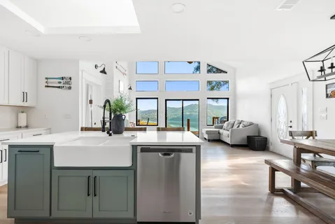 a kitchen with sink refrigerator and large window