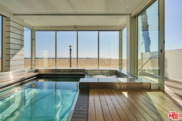 a view of a room with wooden floor and furniture