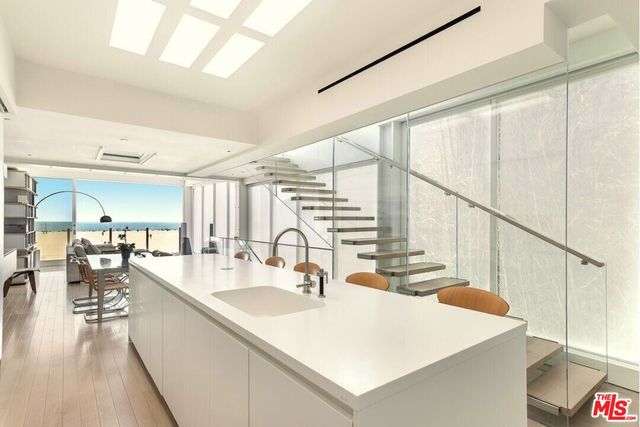 a kitchen with counter top space and wooden floor