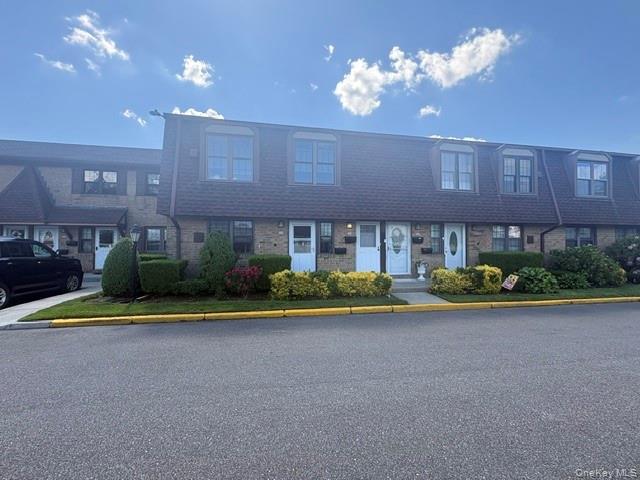 335 Mariners Way Copiague, NY 11726 - Photo 1 of 12 a front view of a house with garden and plants