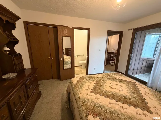 a bedroom with a bed and a mirror