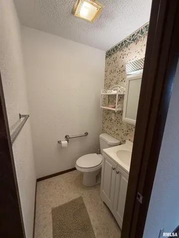a bathroom with a sink a toilet a tub and shower