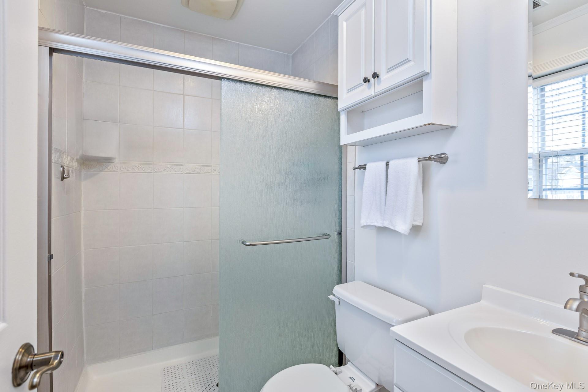 7 Possum Path Coram, NY 11727 - Photo 13 of 22 a white toilet sitting next to a bathroom sink